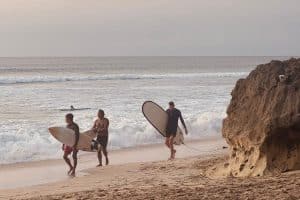 Surfer riding a wave at Dreamland Beach in Uluwatu, Bali.
