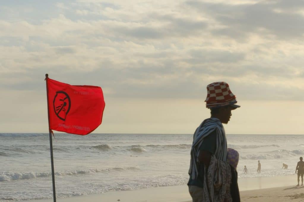 Local man standing on the beach at sunset