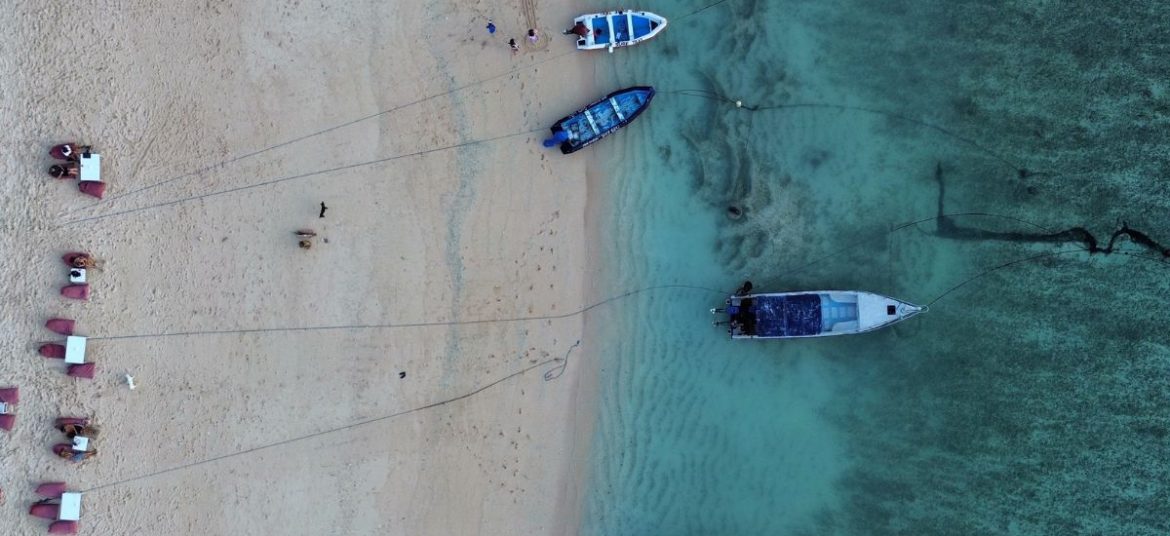 Aerial drone view of clear blue waters around Nusa Lembongan island