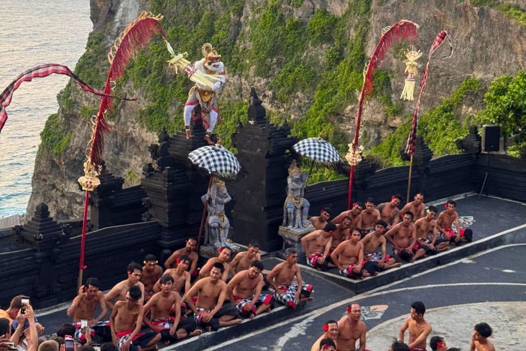 Traditional Kecak dance performance at Uluwatu Temple during sunset