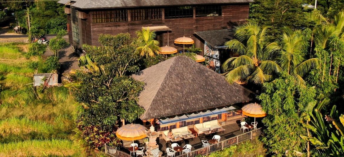 Aerial view of Rüsters Ubud surrounded by rice fields
