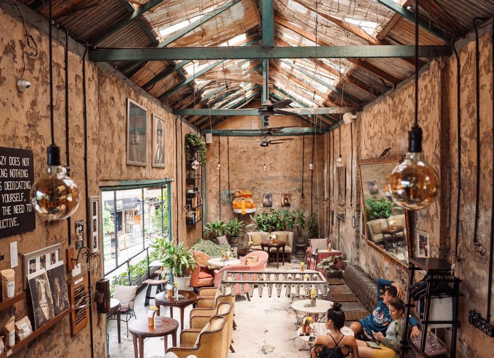Interior of Lazy Cats coffee shop in Canggu, Bali with cozy seating and coffee bar