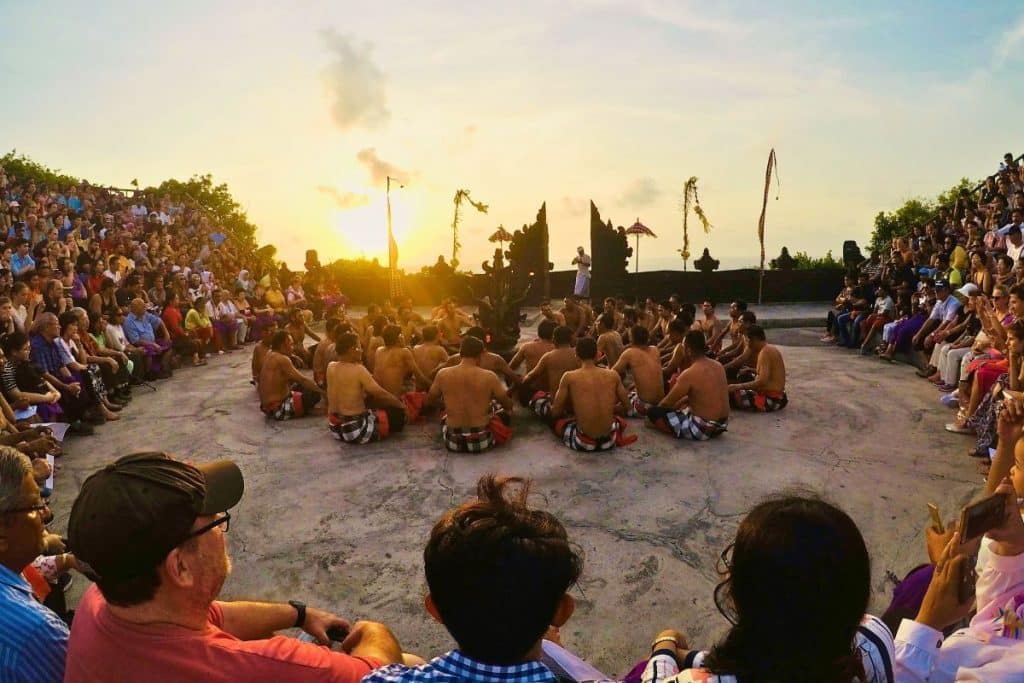 Performers in traditional Kecak dance at Uluwatu Temple during sunset