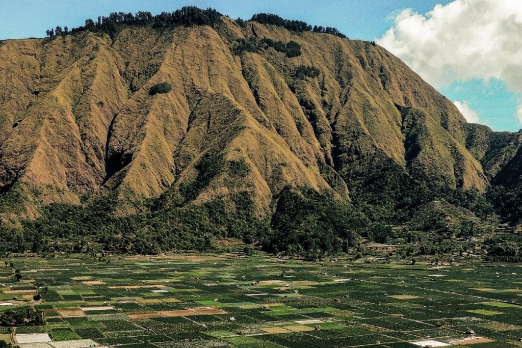 North Lombok Indonesia landscape with lush hills, waterfalls, traditional villages and tropical coastline