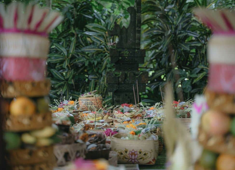 Traditional Balinese offerings with flowers, fruits, and incense