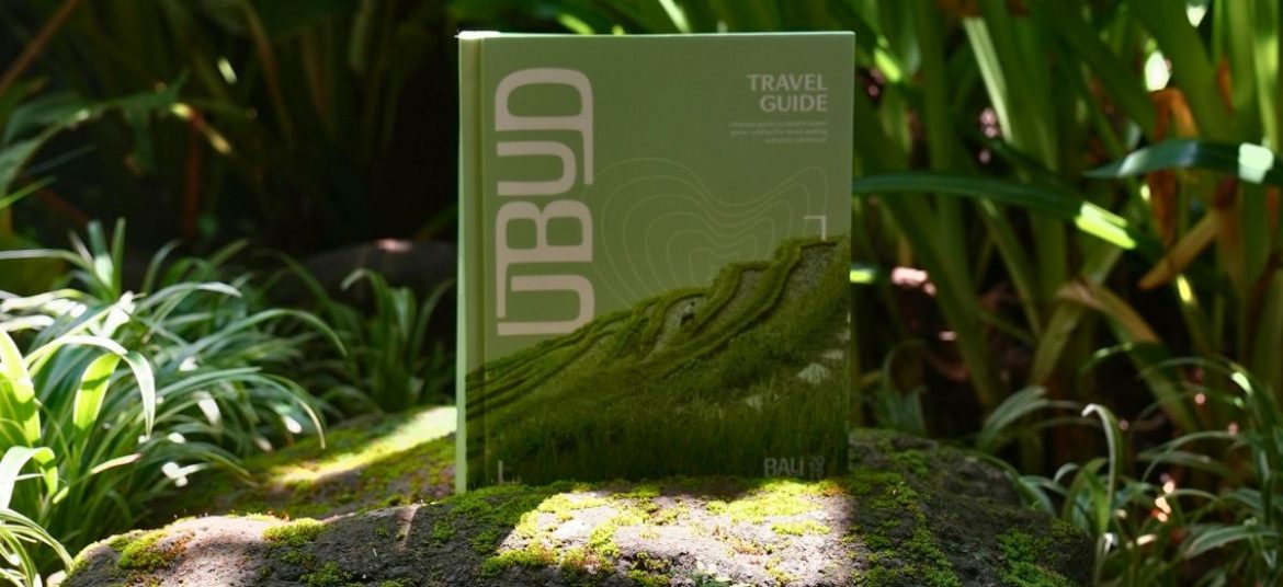 Close-up of the Ubud Travel Guide resting outdoors in a lush natural setting