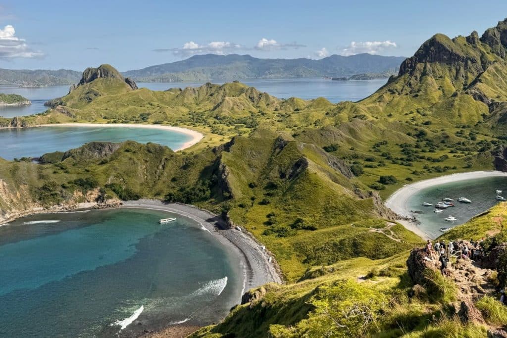 A panoramic view of the iconic ridges and curved bays of Padar Island, seen from the summit.