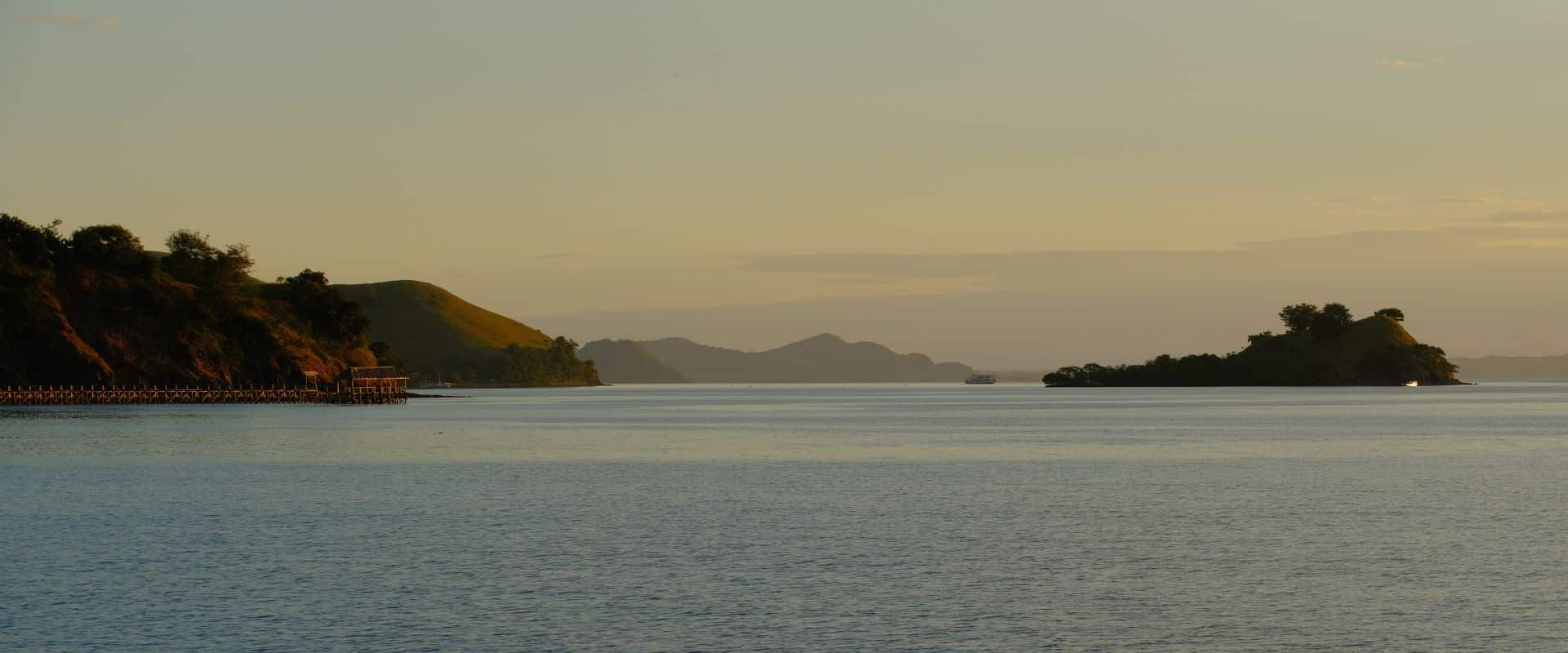 Flores island landscape Indonesia with rolling green hills, tropical coastline and dramatic natural scenery