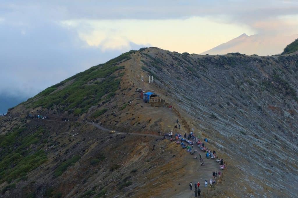 Distant view of Mount Ijen volcano with its rugged slopes and lush surroundings in East Java