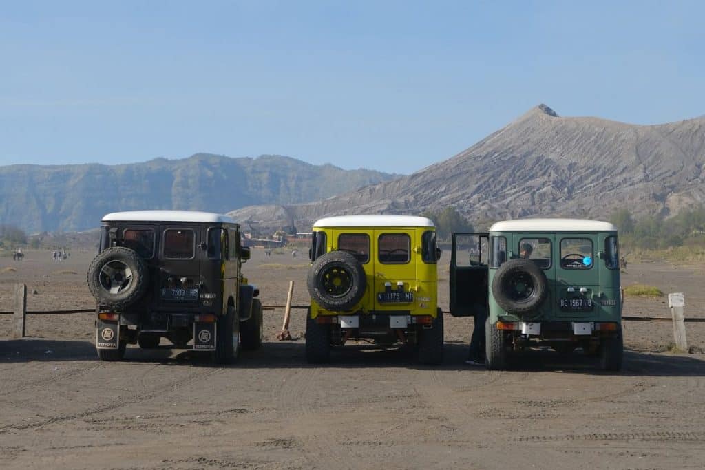 4x4 Jeep crossing the black sand sea of Mount Bromo