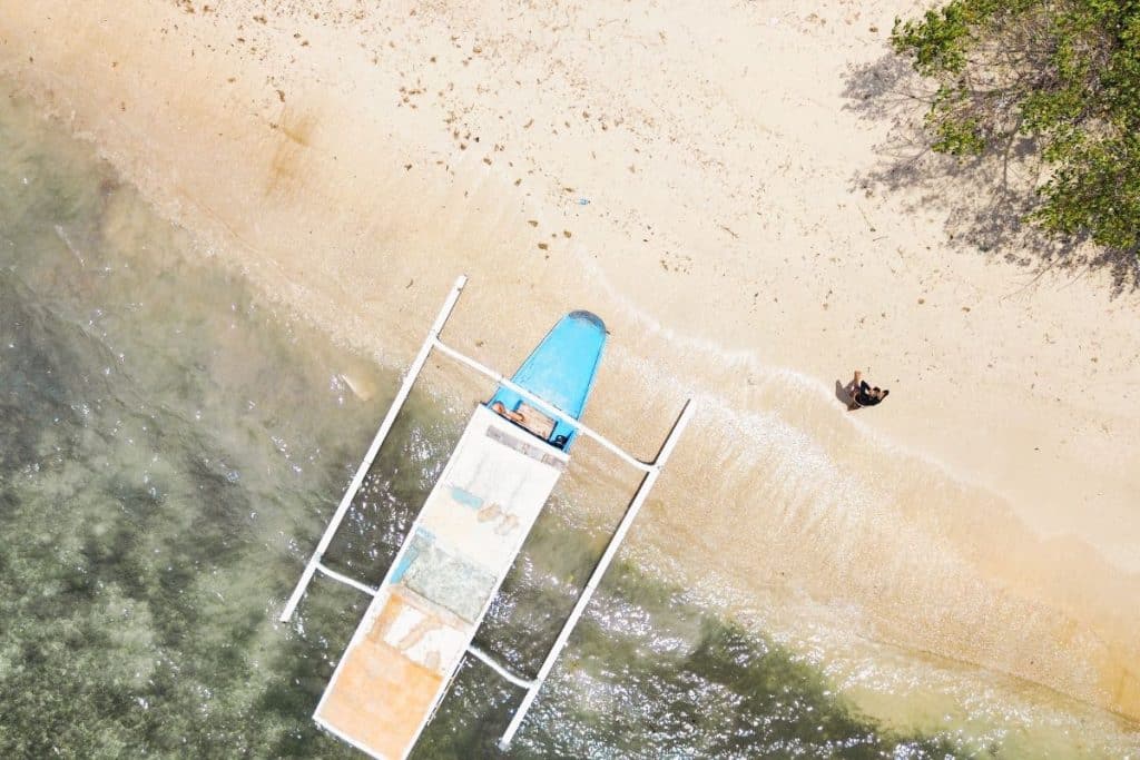 Drone view of a boat sailing around the Secret Gilis in Lombok