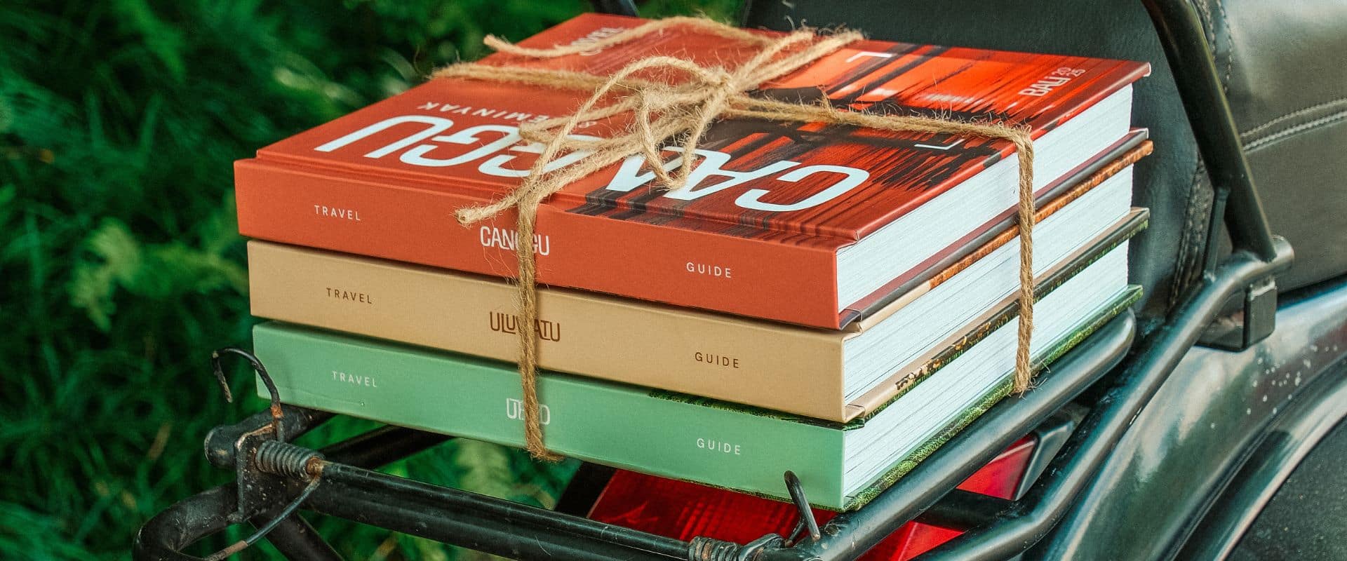 Delivery of travel guides by bike for Christmas, rider carrying wrapped guide books.