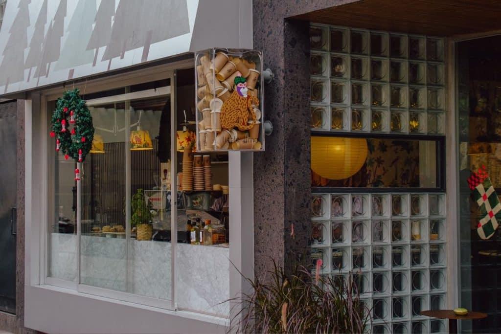 Industrial-style café interior at Little Lima in Pererenan featuring raw concrete, modern design, and minimalist details