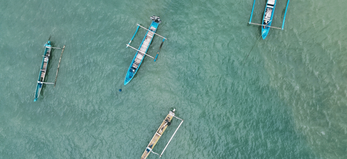 Aerial view of a beach in Lombok with turquoise water and curved shoreline