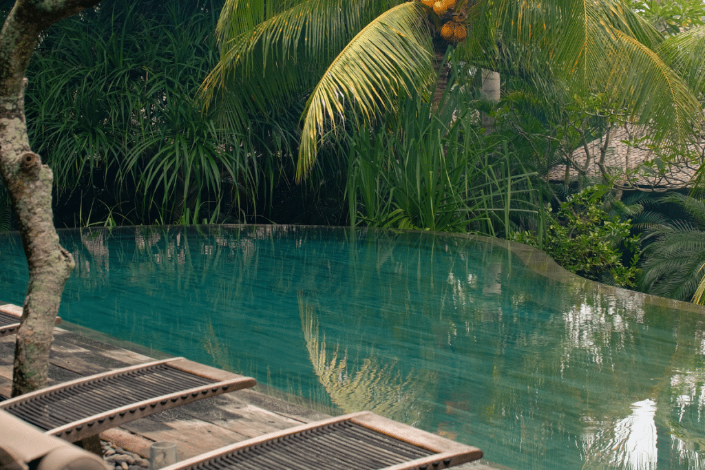 Outdoor swimming pool surrounded by greenery at The Asa Maia Uluwatu