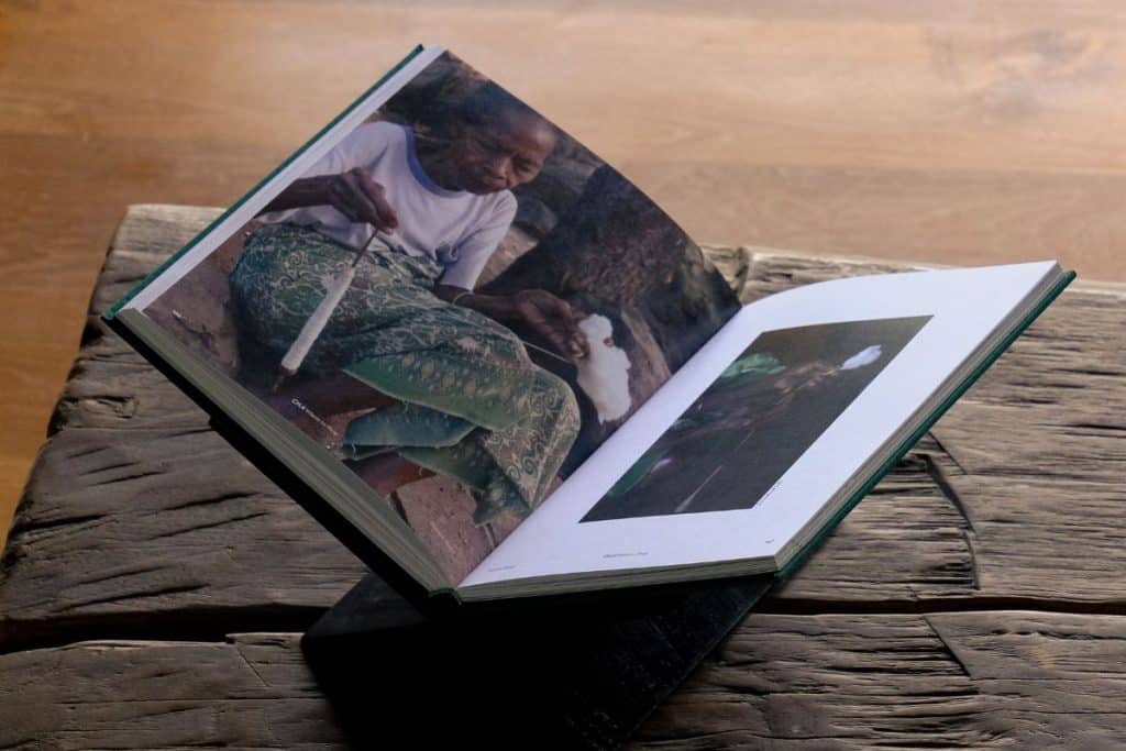 Wooden book holder designed for linen coffee table books