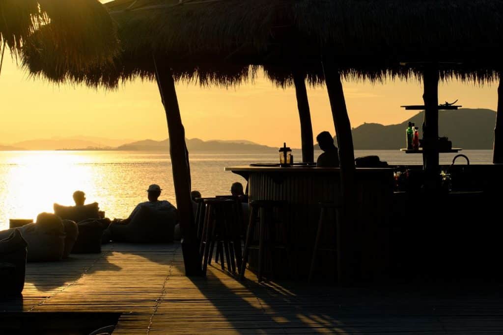 Sunset over Menjaga Bay with warm tones reflecting on the ocean