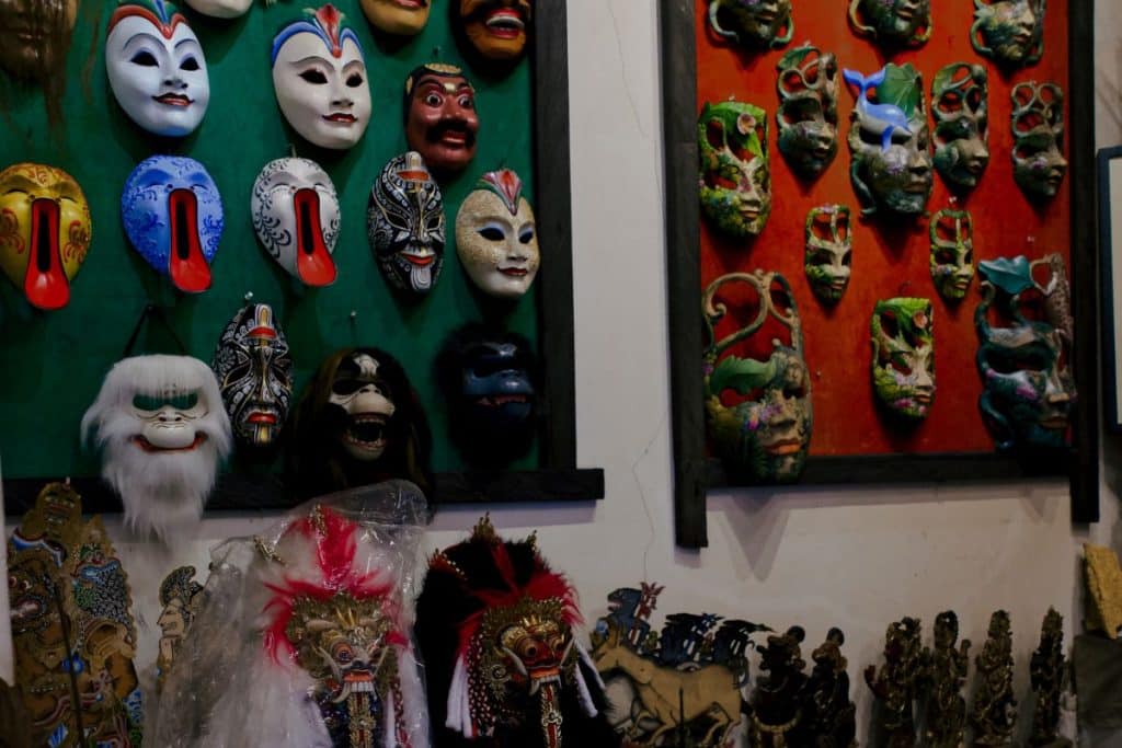 Traditional wood carving gallery filled with Balinese masks and handcrafted artwork in Bali