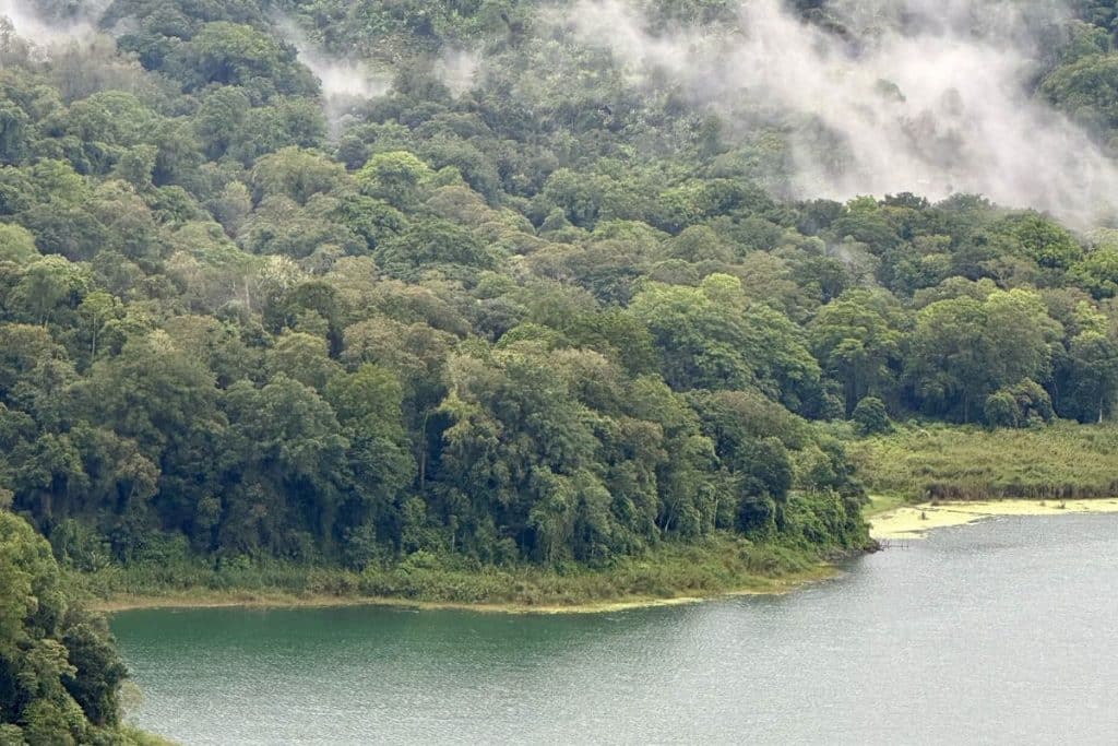 Misty view over Lake Beratan surrounded by mountains in Bedugul