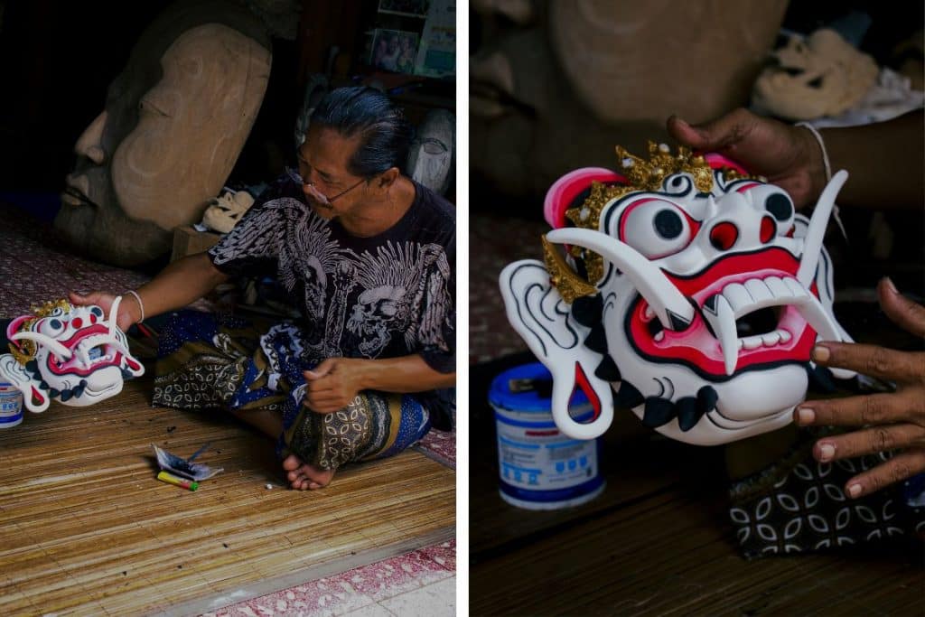 Anom Balinese wood carving artist working on a traditional mask in his Bali workshop