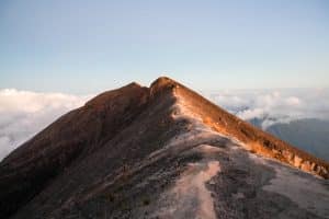 Hikers climbing Mount Agung before sunrise with headlamps along the trail