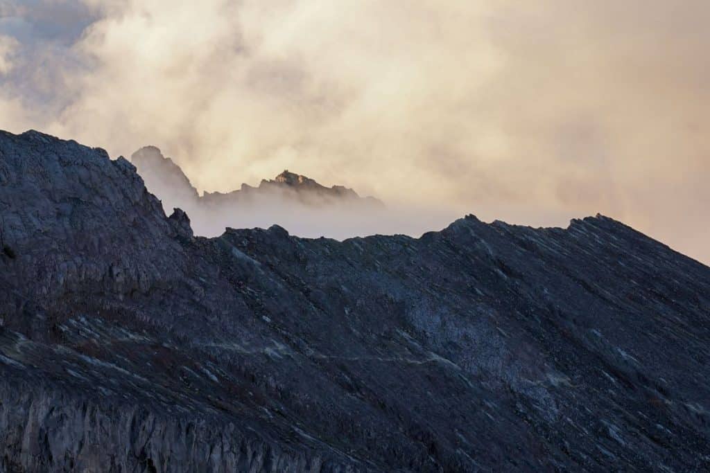 View between the clouds and mountains during the Mount Agung sunrise hike in Bali