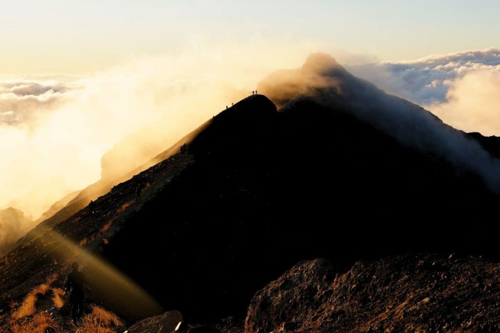 Sunrise over Mount Agung with golden light illuminating Bali's volcanic landscape