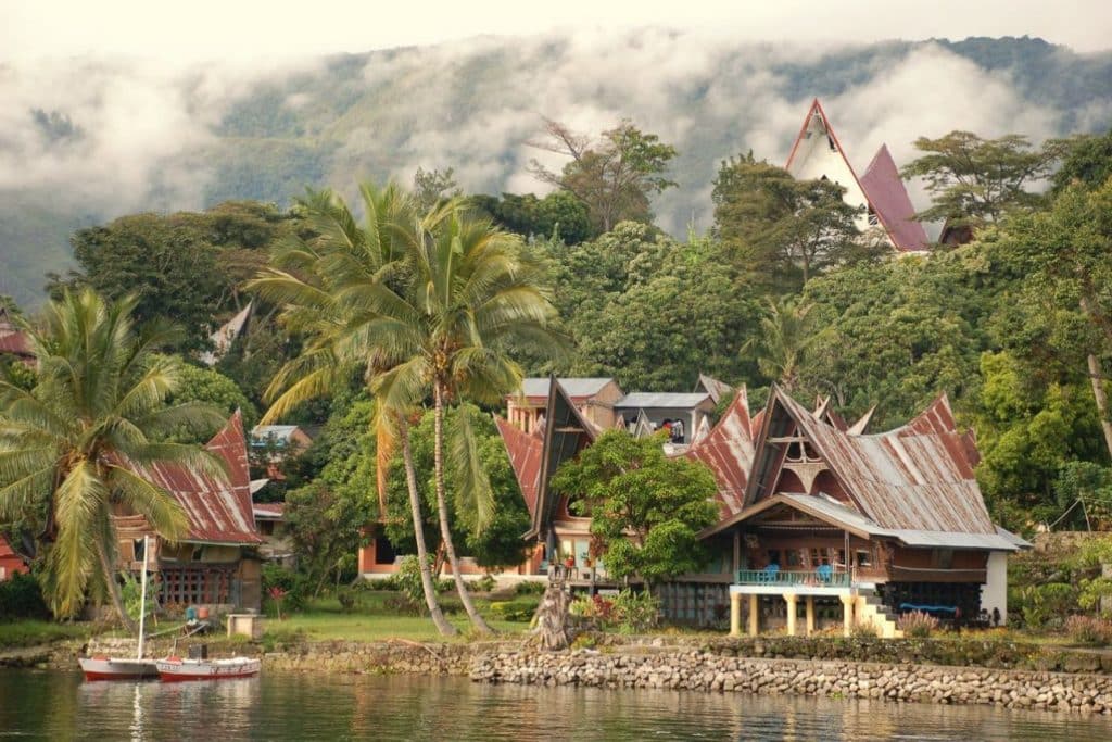 Lake Toba surrounded by green mountains and volcanic landscapes in North Sumatra.