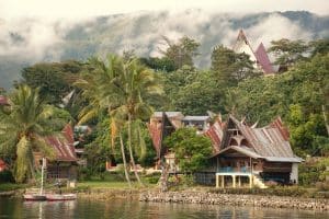 Lake Toba surrounded by green mountains and volcanic landscapes in North Sumatra.