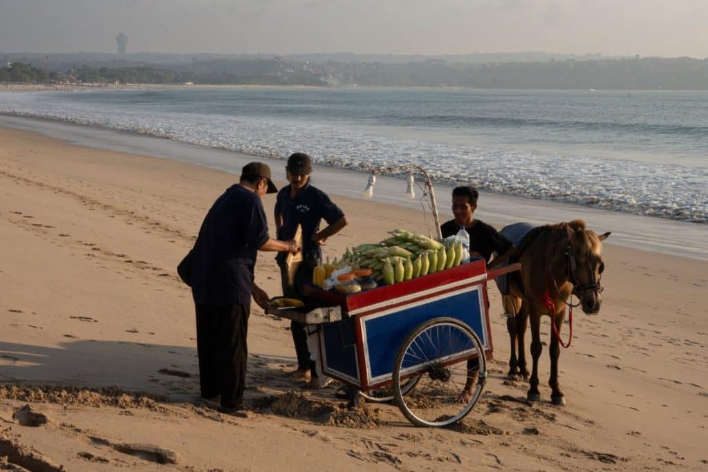 Local vendor selling grilled corn on Jimbaran Beach, Bali