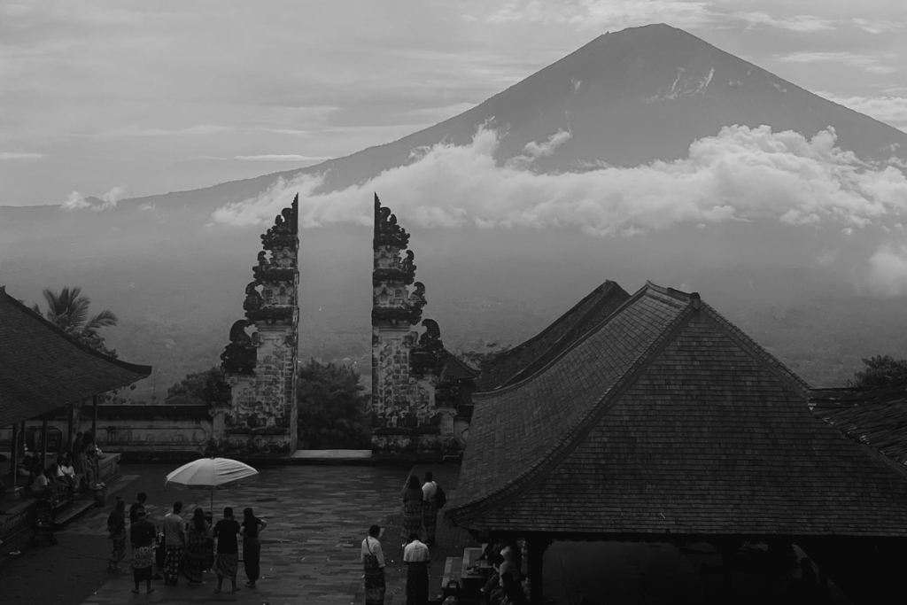 A traditional Balinese split gate framing Mount Agung behind a temple courtyard.