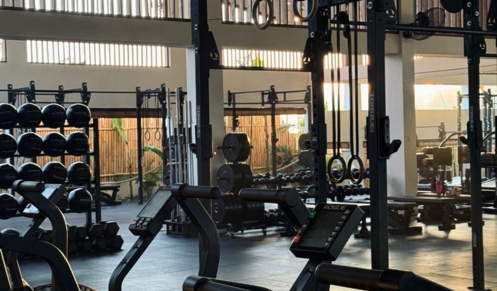 Interior of Bambu Fitness Uluwatu with open and air-conditioned gym areas.