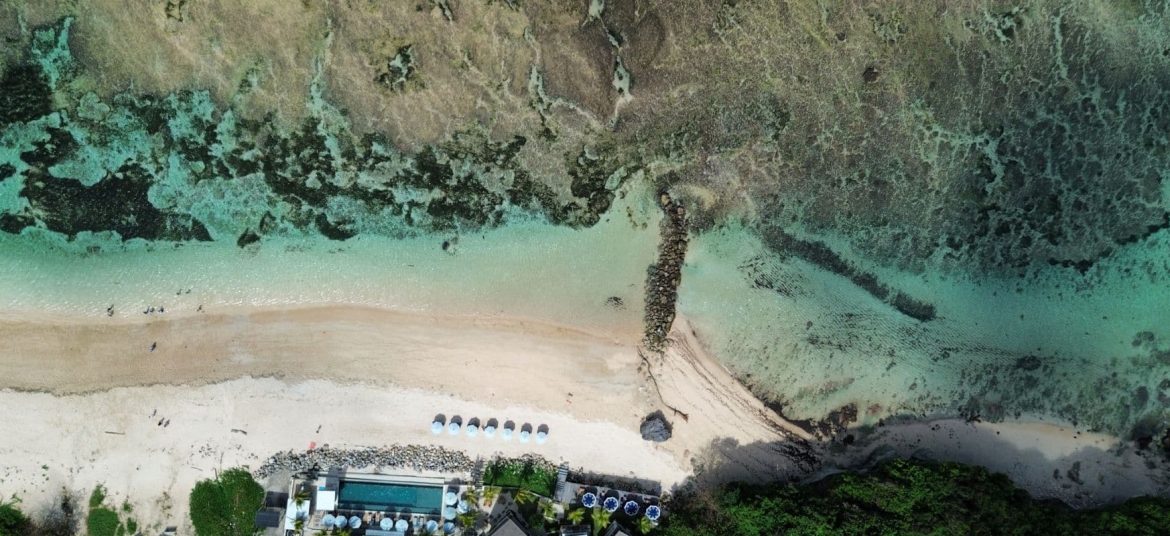Uluwatu beach clubs aerial view cliffs ocean Bali drone shot
