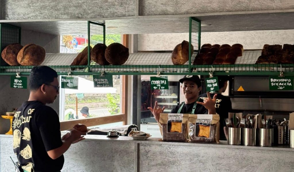 Smiling barista behind the counter at Braud