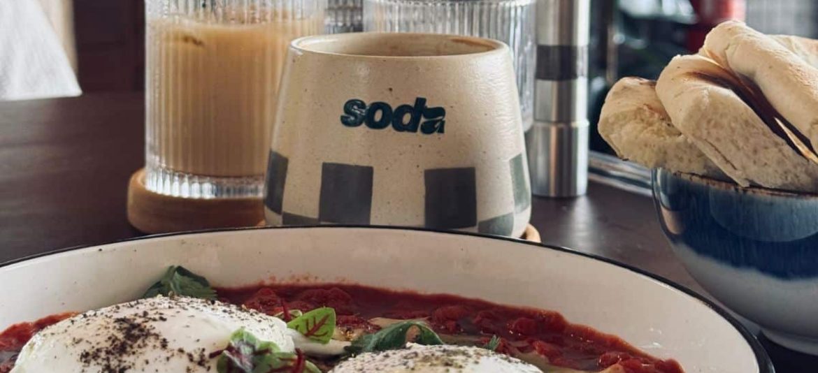 Colorful breakfast plates with smoothie bowls and toast at Soda café