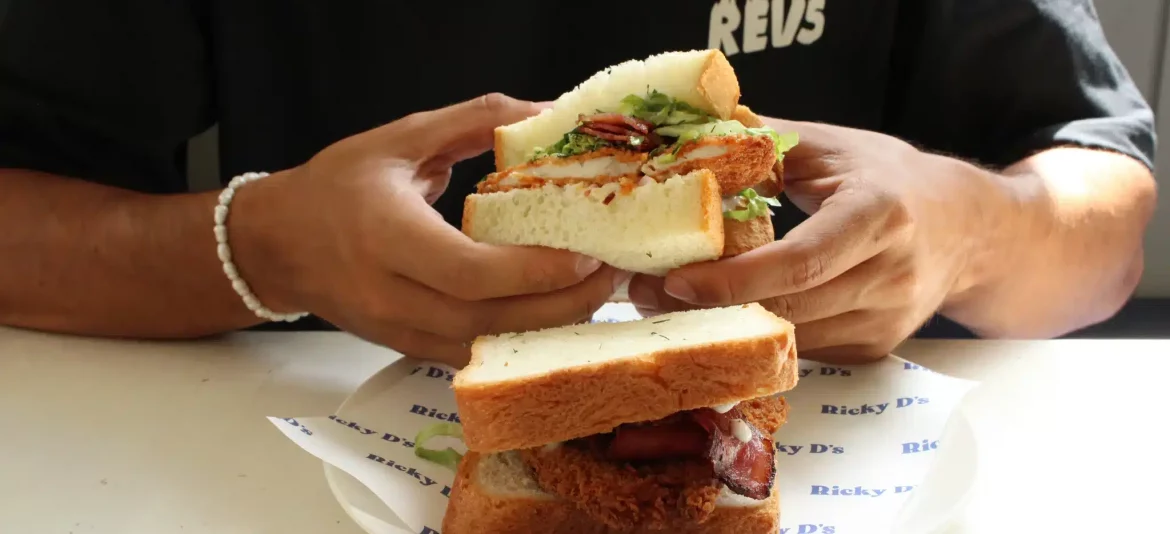 Man holding a sandwich from Ricky Sandwich Bali.
