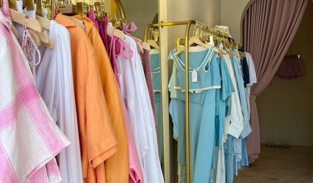 Colorful women’s clothing displayed inside Pretty Things boutique