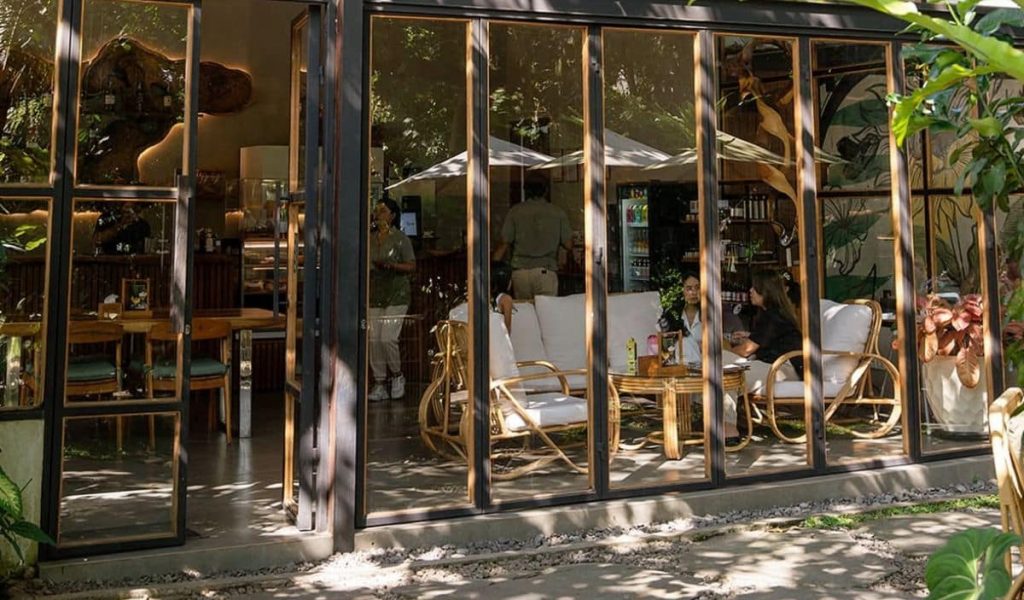 Kalos Bali welcomes you with a charming outdoor entrance surrounded by greenery.