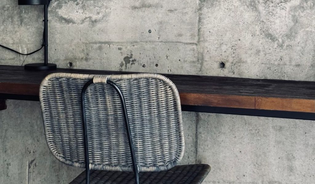 Industrial-style reception desk at Kasia Boutique Hotel in Ungasan featuring raw concrete, clean lines, and minimalist design