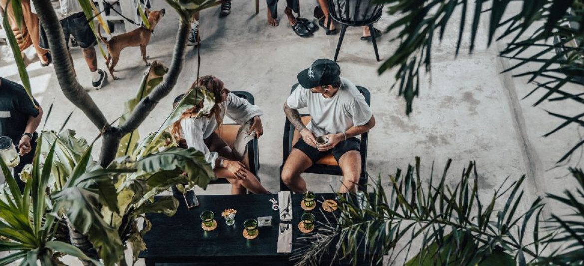 Person enjoying a meal at Suburbia café with raw concrete interior