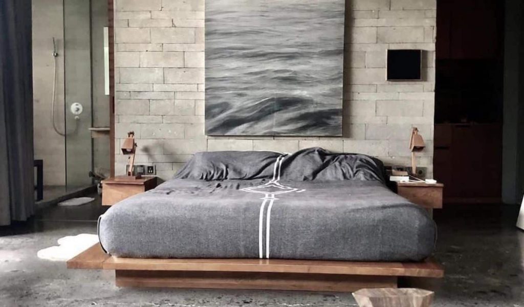 Industrial-style interior at The Slow in Canggu featuring raw concrete, modern art, and minimalist design