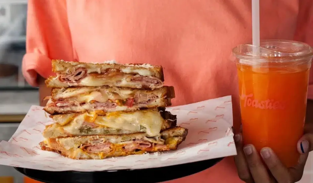 Woman holding a toasted sandwich from Toasties Bali.