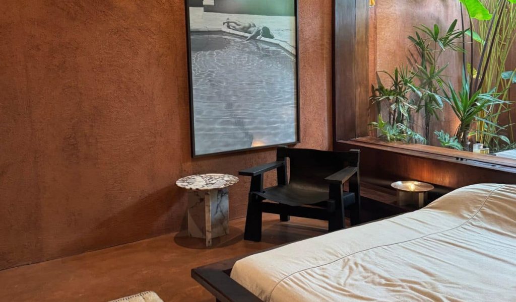 Further Hotel room with minimalist terracotta tones and modern lines