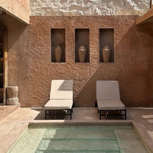 Terracotta-toned pool area at Villa Malika with tropical surroundings