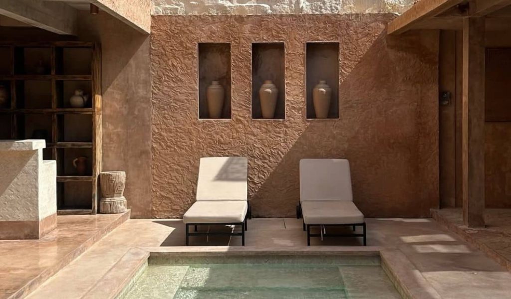 Terracotta-toned pool area at Villa Malika with tropical surroundings