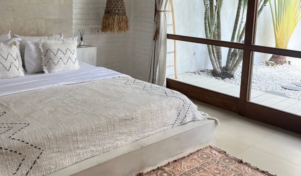 Bright, modern bedroom at Villa Magnolia with tropical touches