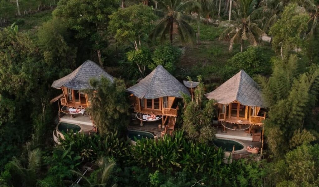 Aerial view of bamboo villas at Kalma Eco Lodge in nature