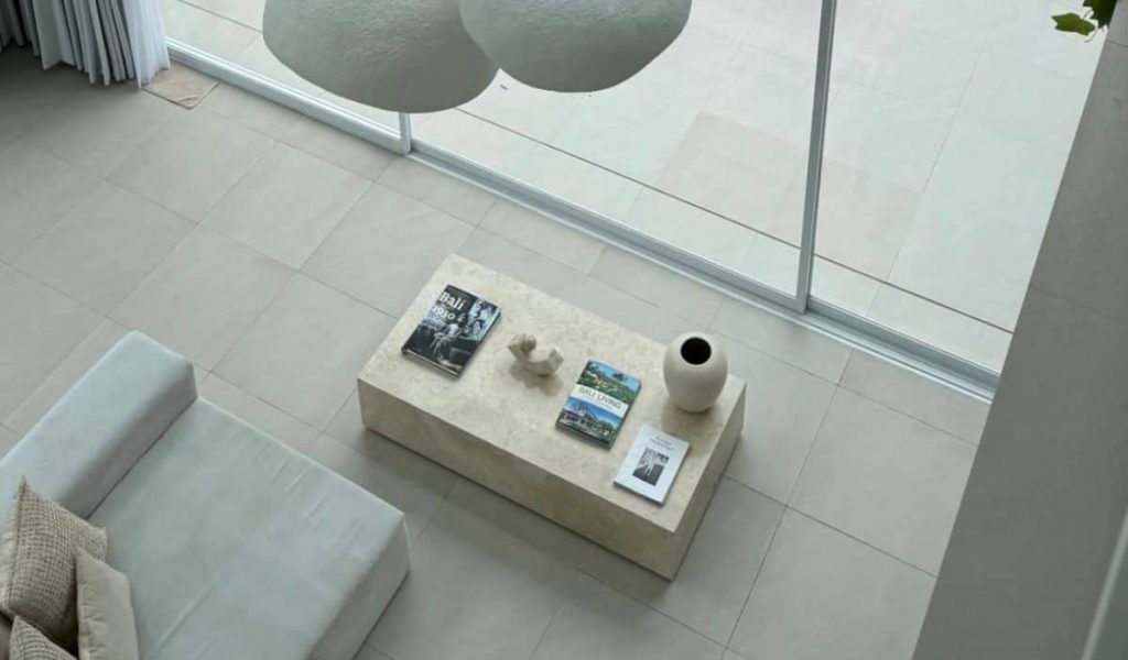 Minimalist living room at Mayani Villa with high ceilings and large windows