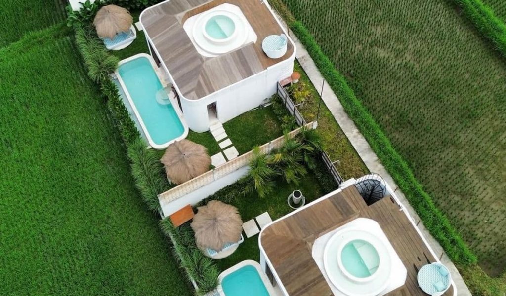 Aerial drone view of private villas surrounded by tropical landscape at Woy Woy Escape