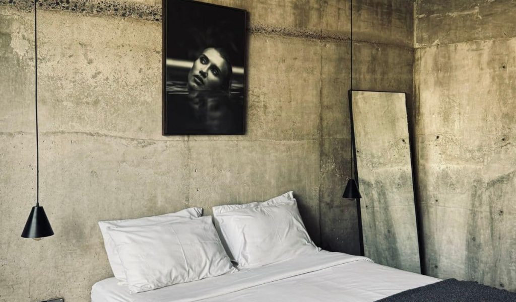 Minimalist bedroom with concrete walls at Kasia